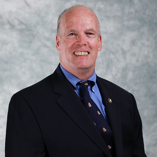 head shot of smiling bald person